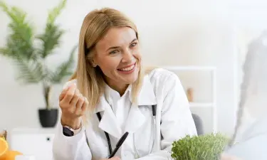 West Virginia family nurse practitioner smiling with pediatric patient during appointment